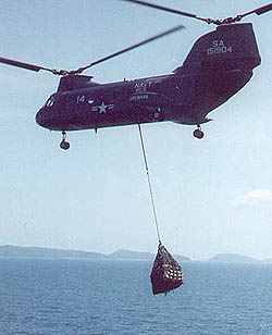 Navy H-46 (HC-3) carrying a sling load between ships. Off the South Vietnamese coast, 1971.