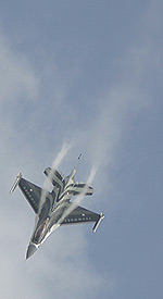 F-16 parts the early morning clouds