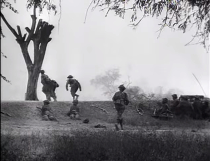 Infantry shelter beihind a smokescreen during the attack on Fort Dufferin, 10th March 1945